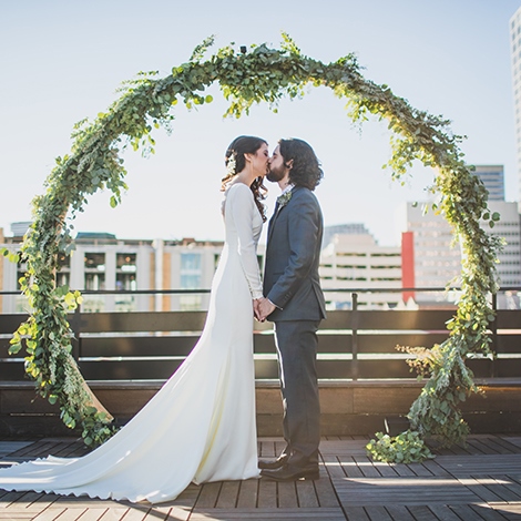 Custom Made Round Bent Wood Wedding Arch Covered With Greenery New Orleans Outdoor Rooftop Wedding Sully Clemmer Photography 015crp1st